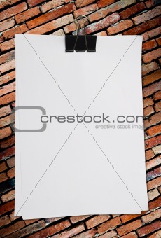 white blank note paper on old brick wall