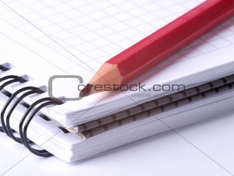 Red pencil on notepad