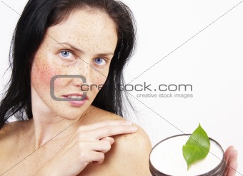 Beautiful brunette woman with body cream