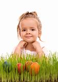 Happy easter girl with colorful eggs in fresh grass