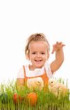 Happy laughing little girl with spring chicks and easter eggs