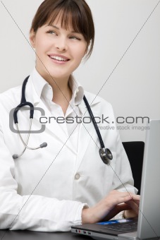 portrait of a young caucasian woman doctor with laptop
