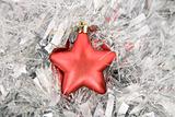red star, christmas decoration on silver tinsel