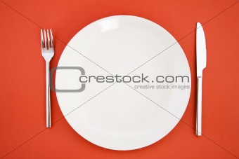 Knife, white plate and fork
