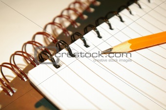pencil laying on a notebook