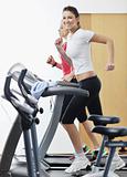 womanworkout  in fitness club on running track machine 