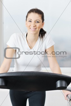 woman workout  in fitness club on running track 