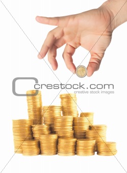 man hand with coin and many coins in column