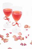two red wine and rose petals