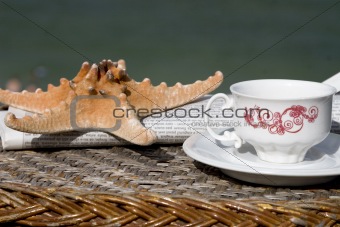 coffee cup, newspaper and starfish