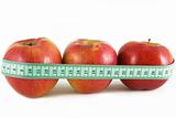 three red apple and green measurement tape