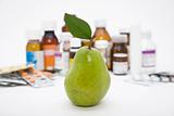 green pear in front of pills