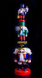 Three wooden nutcracker toys standing on each other