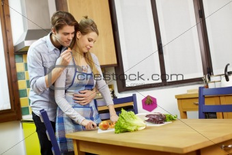 couple cooking vegetables in domestic kitchen