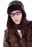 Young boy looking serious, with winter clothes, glasses and hat, isolated on white, studio shot