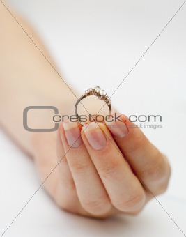 engagement ring held in hand