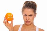 Offended woman with dissatisfied orange