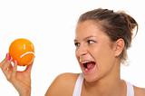 Woman holds orange with insult