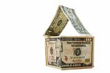 Dollars forming a house on white background