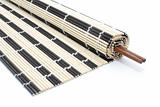 Half-rolled bamboo mat with chopsticks on white
