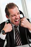 Stressed businessman screaming on the phone