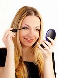 Beautiful woman applying mascara