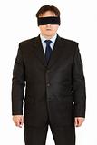 Disoriented businessman with blindfold on eyes
