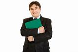 Smiling  businessman hugging  folder with documents
