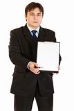 Serious modern businessman with documents and pen for your signing
