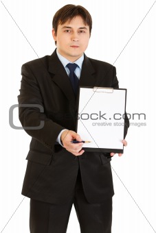 Serious modern businessman with documents and pen for your signing
