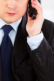 Concentrated businessman talking on mobile phone. Close -up. 
