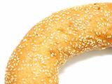 A part of bagel with sesame seeds on white