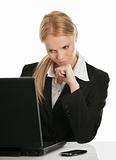 Thoughful business woman working on laptop