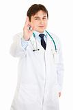 Smiling young medical doctor showing ok gesture
