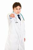 Confident young medical doctor pointing finger at you
