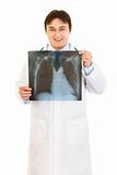 Smiling medical doctor holding thorax  x-ray in hands
