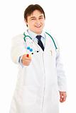 Smiling medical doctor holding test tubes in hand
