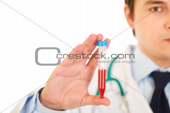 Medical doctor holding blood sample in hand. Close-up.
