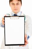 Medical doctor holding blank clipboard in hand. Close-up.
