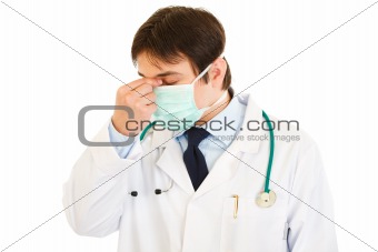 Tired medical doctor with mask on face
