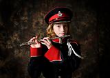 girl in a band uniform holding her flute