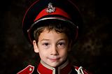 cute little boy in a uniform hat