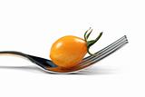 Yellow tomato and fork