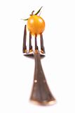 Yellow tomato and fork