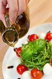 Olive Oil Dressing on Tomato Mozzarella Rocket & Basil Salad 