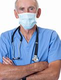 Male surgeon in blue scrubs and face mask