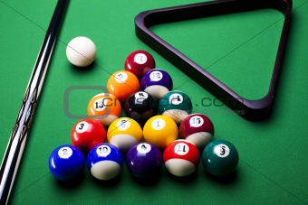 Pool game balls against a green