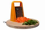Grated carrots and parsley on a bamboo kitchen board