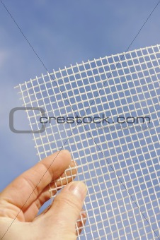 Detail of glass-fiber mesh in hand - reinforcing material for insulation