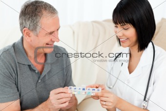 Nurse showing pills to her patient